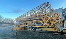 Potain HUP 32-27 self-erecting crane in transport position, staged and ready for fast setup.